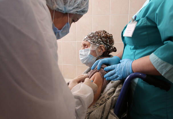 VOLGOGRAD, RUSSIA - JANUARY 18, 2021: A woman is vaccinated with Gam-COVID-Vac (Sputnik V), a COVID-19 vaccine, at the Volgograd nursing home for the elderly and disabled. Dmitry Rogulin TASS  TS0F48AF