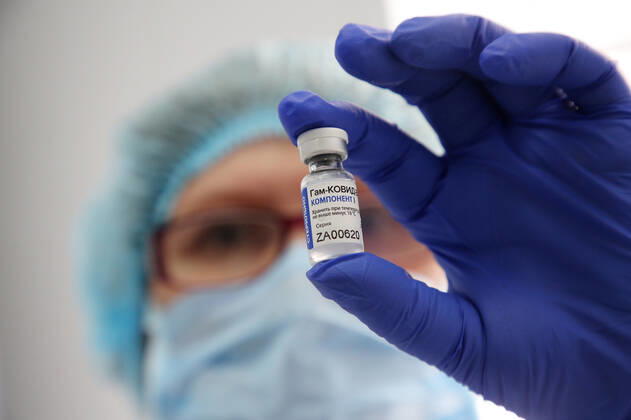 VOLGOGRAD, RUSSIA - JANUARY 18, 2021: A nurse holds a bottle with Gam-COVID-Vac (Sputnik V), a COVID-19 vaccine, at the Volgograd nursing home for the elderly and disabled. Dmitry Rogulin TASS  TS0F48CB