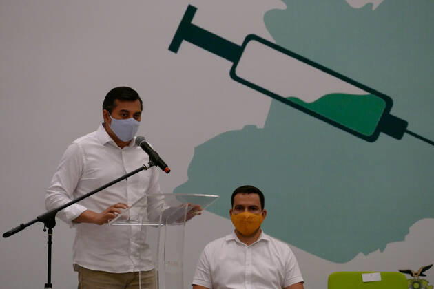 MANAUS, AM - 18.01.2021: ENFERMEIRA INDÍGENA É VACINADA EM MANAUS - Vanda Ortega, a 33-year-old nursing technician, was the first citizen of Amazonas to receive the vaccine against Covid-19, in Manaus (AM), on Monday night (18), at the launch of the vaccination campaign in State, at the Vasco Vasques Convention Center. In the photo, Wilson Lima, Governor of the State. x2020147x  SandroxPereira