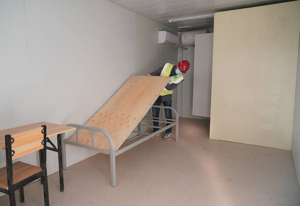 (210119) -- SHIJIAZHUANG, Jan. 19, 2021 -- A worker installs beds in the first batch of buildings to be delivered at Huangzhuang Apartment COVID-19 quarantine center in Shijiazhuang, north China s Hebei Province, Jan. 19, 2021. With 606 quarantine rooms and supporting facilities delivered on Tuesday, the construction of the Huangzhuang Apartment COVID-19 quarantine center in Shijiazhuang is about to be completed. Close contacts and sub-close contacts of confirmed COVID-19 patients will be placed under medical observation in the new center with a total of 4,156 rooms. ) CHINA-HEBEI-SHIJIAZHUANG-COVID-19-QUARANTINE CENTER-CONSTRUCTION (CN) YangxShiyao 