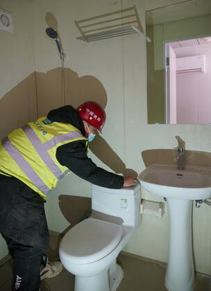 (210119) -- SHIJIAZHUANG, Jan. 19, 2021 -- A worker tidies up the room in the first batch of buildings to be delivered at Huangzhuang Apartment COVID-19 quarantine center in Shijiazhuang, north China s Hebei Province, Jan. 19, 2021. With 606 quarantine rooms and supporting facilities delivered on Tuesday, the construction of the Huangzhuang Apartment COVID-19 quarantine center in Shijiazhuang is about to be completed. Close contacts and sub-close contacts of confirmed COVID-19 patients will be placed under medical observation in the new center with a total of 4,156 rooms. ) CHINA-HEBEI-SHIJIAZHUANG-COVID-19-QUARANTINE CENTER-CONSTRUCTION (CN) YangxShiyao 