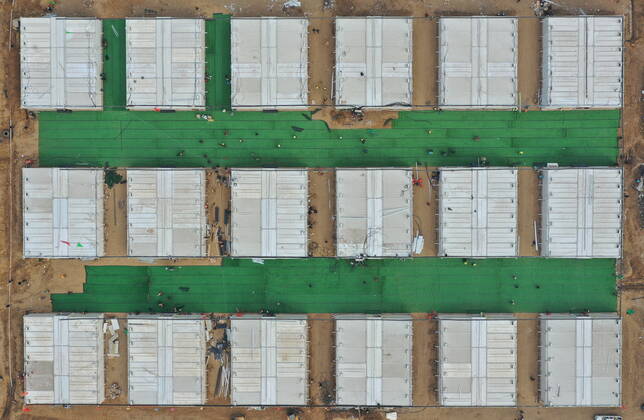 (210119) -- SHIJIAZHUANG, Jan. 19, 2021 -- Aerial photo shows workers tidying up the ground of the first batch of buildings to be delivered at Huangzhuang Apartment COVID-19 quarantine center in Shijiazhuang, north China s Hebei Province, Jan. 19, 2021. With 606 quarantine rooms and supporting facilities delivered on Tuesday, the construction of the Huangzhuang Apartment COVID-19 quarantine center in Shijiazhuang is about to be completed. Close contacts and sub-close contacts of confirmed COVID-19 patients will be placed under medical observation in the new center with a total of 4,156 rooms. ) CHINA-HEBEI-SHIJIAZHUANG-COVID-19-QUARANTINE CENTER-CONSTRUCTION (CN) YangxShiyao 