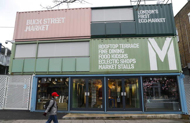 (210120) -- LONDON, Jan. 20, 2021 -- A woman wearing a face mask walks past the closed Buck Street Market in London, Britain, on Jan. 19, 2021. The number of people who have died within 28 days of a positive coronavirus test has surpassed the grim milestone of 90,000 in Britain after another 1,610 were confirmed, according to official figures released Tuesday. The latest daily death toll, the highest since the pandemic began in the country, brought the total number of coronavirus-related deaths in Britain to 91,470, the data showed. ) BRITAIN-LONDON-COVID-19-DEATH TOLL HanxYan