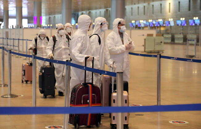 (210120) -- TEL AVIV, Jan. 20, 2021 -- Passengers wearing protective suits and masks are seen at Ben Gurion International Airport near Tel Aviv, Israel, Jan. 19, 2021. Israel s cabinet decided on Tuesday to extend by 10 days a weeks-long nationwide lockdown to curb the spread of the COVID-19 pandemic. The ministers voted in favor of extending the tight lockdown until Jan. 31, according to a cabinet statement. The cabinet also decided that travelers entering the country will be required to present a negative coronavirus test taken within 72 hours before their flight. (Gideon Markowicz JINI via Xinhua) ISRAEL-TEL AVIV-AIRPORT-COVID-19 ShangxHao 
