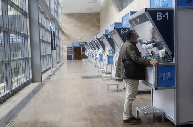 (210120) -- TEL AVIV, Jan. 20, 2021 -- A staff member takes samples from a passenger at a COVID-19 testing booth at Ben Gurion International Airport near Tel Aviv, Israel, Jan. 19, 2021. Israel s cabinet decided on Tuesday to extend by 10 days a weeks-long nationwide lockdown to curb the spread of the COVID-19 pandemic. The ministers voted in favor of extending the tight lockdown until Jan. 31, according to a cabinet statement. The cabinet also decided that travelers entering the country will be required to present a negative coronavirus test taken within 72 hours before their flight. (Photo by Gil Cohen Magen Xinhua) ISRAEL-TEL AVIV-AIRPORT-COVID-19 ShangxHao 
