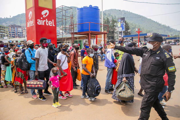 (210120) -- KIGALI, Jan. 20, 2021 -- A police officer guides passengers at a bus station in Kigali, Rwanda, Jan. 19, 2021. Rwandan cabinet on Monday brought the capital city of Kigali back to a lockdown due to a surge in COVID-19 cases. The lockdown, which became effective immediately and will be reviewed after 15 days, prohibits unnecessary movements in the city. (Photo by Xinhua) RWANDA-KIGALI-COVID-19-LOCKDOWN CyrilxNdegeya 
