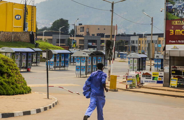 (210120) -- KIGALI, Jan. 20, 2021 -- A man runs past an empty bus station in Kigali, Rwanda, Jan. 19, 2021. Rwandan cabinet on Monday brought the capital city of Kigali back to a lockdown due to a surge in COVID-19 cases. The lockdown, which became effective immediately and will be reviewed after 15 days, prohibits unnecessary movements in the city. (Photo by Xinhua) RWANDA-KIGALI-COVID-19-LOCKDOWN CyrilxNdegeya 
