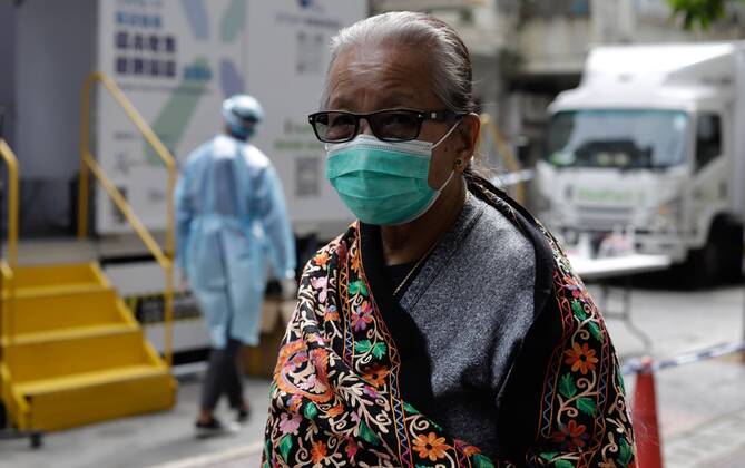 January 20, 2021, Hong Kong, CHINA: Nepali woman walk through sealed street in designated zone where cluster explosion of Covid-19 were identified among ethnic communities in last 4 days typically represented by Nepalis, Pakistani and Indian.Jan-20,2021Hong Kong.ZUMA Hong Kong CHINA - ZUMAl137 20210120_zap_l137_013 Copyright: xLiauxChung-renx