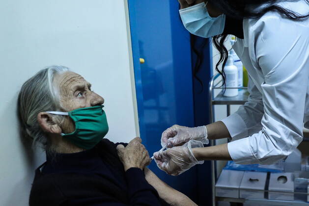 January 20, 2021, Athens, Greece: An elderly woman over 85 years old prepares to receive a shot of the first dose of the Pfizer-BioNTech vaccine against the coronavirus disease (COVID-19), in a vaccine center in Athens. Athens Greece - ZUMAe114 20210120_zaa_e114_004 Copyright: xEurokinissix