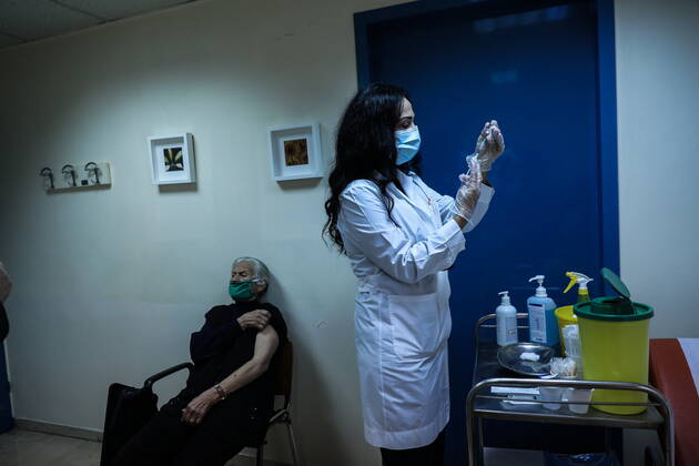 January 20, 2021, Athens, Greece: An elderly woman over 85 years old prepares to receive a shot of the first dose of the Pfizer-BioNTech vaccine against the coronavirus disease (COVID-19), in a vaccine center in Athens. Athens Greece - ZUMAe114 20210120_zaa_e114_006 Copyright: xEurokinissix