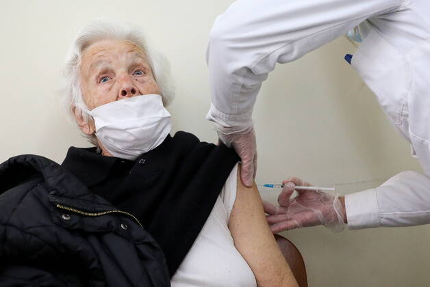 January 20, 2021, Athens, Greece: An elderly woman over 85 years old prepares to receive a shot of the first dose of the Pfizer-BioNTech vaccine against the coronavirus disease (COVID-19), in a vaccine center in Athens. Athens Greece - ZUMAe114 20210120_zaa_e114_008 Copyright: xEurokinissix