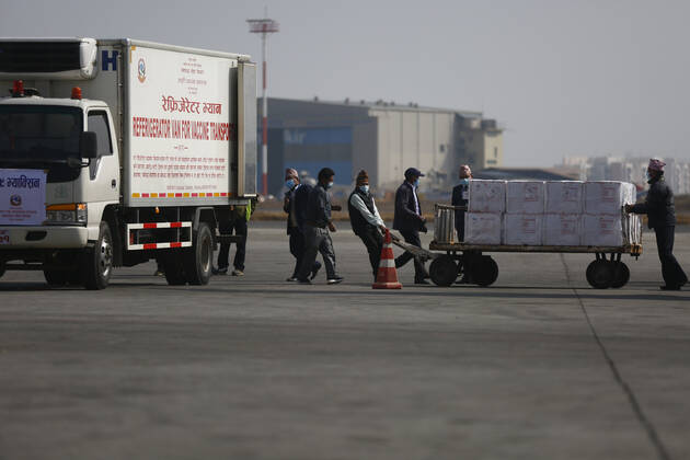 January 21, 2021, Kathmandu, Nepal: Airport staff unload Covid-19 AstraZeneca vaccines from Air India aircraft at Tribhuvan International Airport in Kathmandu, Nepal on Thursday, January 21, 2021. India under the Ã¢â‚¬ËœVaccine MaitriÃ¢â‚¬Â initiative is providing vaccines, in aid to Nepal with 1 million doses of vaccine against the coronavirus. Kathmandu Nepal - ZUMAg200 20210121_zap_g200_006 Copyright: xSkandaxGautamx
