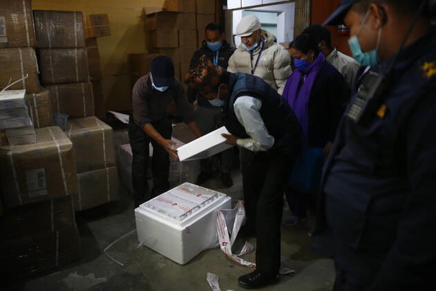 January 21, 2021, Kathmandu, Nepal: Health workers open Covid-19 AstraZeneca vaccines that arrived from India at Department of Health Services in Kathmandu, Nepal on Thursday, January 21, 2021. India under the Ã¢â‚¬ËœVaccine MaitriÃ¢â‚¬Â initiative is providing vaccines, in aid to Nepal with 1 million doses of vaccine against the coronavirus. Kathmandu Nepal - ZUMAg200 20210121_zap_g200_009 Copyright: xSkandaxGautamx