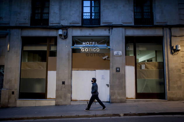 January 21, 2021, Barcelona, Spain: A man wearing a face mask walks past a closed and boarded-up hotel in Barcelona. The coronavirus pandemic has sunk hotel investment in Barcelona in 2020 by 41 percent compared to the previous year, last year the sector suffered a 95 percent drop in billing and customers in hotels. Recently, the Catalan regional government has once again reduced the capacity of establishments, has limited the opening of bars and restaurants and has tightened the requirements for social gatherings or curfew hours, which makes it impossible for visitors to arrive in Barcelona. Over the last few weeks, more than 50 hotels in the city have closed. Barcelona Spain - ZUMAb137 20210121_zap_b137_001 Copyright: xJordixBoixareux