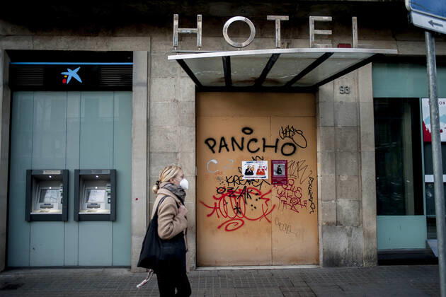 January 21, 2021, Barcelona, Spain: A woman wearing a face mask walks past a closed and boarded-up hotel in Barcelona. The coronavirus pandemic has sunk hotel investment in Barcelona in 2020 by 41 percent compared to the previous year, last year the sector suffered a 95 percent drop in billing and customers in hotels. Recently, the Catalan regional government has once again reduced the capacity of establishments, has limited the opening of bars and restaurants and has tightened the requirements for social gatherings or curfew hours, which makes it impossible for visitors to arrive in Barcelona. Over the last few weeks, more than 50 hotels in the city have closed. Barcelona Spain - ZUMAb137 20210121_zap_b137_009 Copyright: xJordixBoixareux