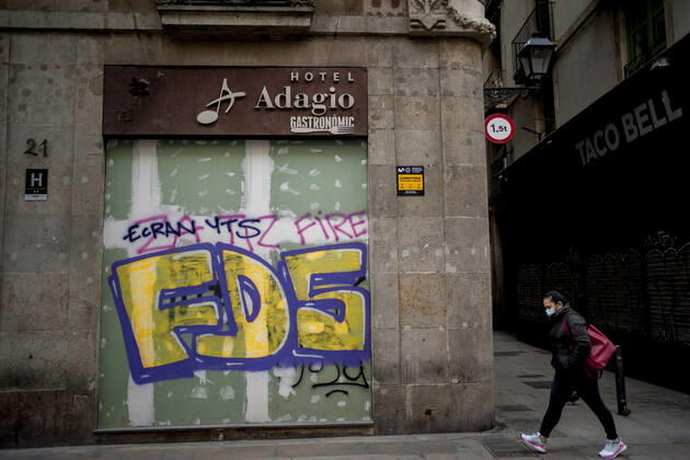 January 21, 2021, Barcelona, Spain: A woman wearing a face mask walks past a closed and boarded-up hotel in Barcelona. The coronavirus pandemic has sunk hotel investment in Barcelona in 2020 by 41 percent compared to the previous year, last year the sector suffered a 95 percent drop in billing and customers in hotels. Recently, the Catalan regional government has once again reduced the capacity of establishments, has limited the opening of bars and restaurants and has tightened the requirements for social gatherings or curfew hours, which makes it impossible for visitors to arrive in Barcelona. Over the last few weeks, more than 50 hotels in the city have closed. Barcelona Spain - ZUMAb137 20210121_zap_b137_012 Copyright: xJordixBoixareux