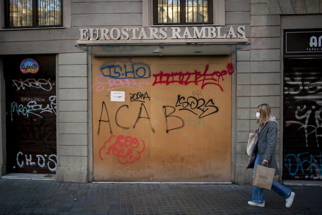 January 21, 2021, Barcelona, Spain: A woman wearing a face mask walks past a closed and boarded-up hotel in La Rambla of Barcelona. The coronavirus pandemic has sunk hotel investment in Barcelona in 2020 by 41 percent compared to the previous year, last year the sector suffered a 95 percent drop in billing and customers in hotels. Recently, the Catalan regional government has once again reduced the capacity of establishments, has limited the opening of bars and restaurants and has tightened the requirements for social gatherings or curfew hours, which makes it impossible for visitors to arrive in Barcelona. Over the last few weeks, more than 50 hotels in the city have closed. Barcelona Spain - ZUMAb137 20210121_zap_b137_015 Copyright: xJordixBoixareux
