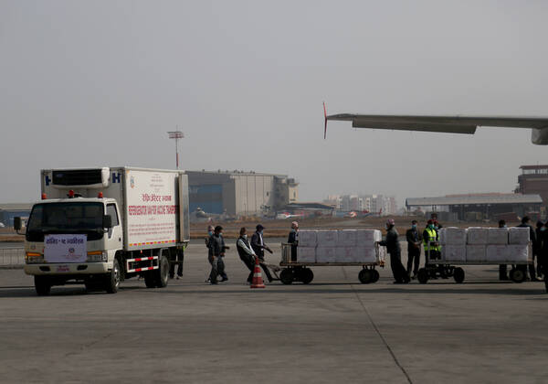 January 21, 2021, Kathmandu, Nepal: Nepalese airport ground staffs pull a trolly full of boxes containing AstraZeneca Oxford University vaccine, manufactured under license by Serum Institute of India, arrive at Tribhuvan International Airport in Kathmandu, Nepal, Thursday, Jan. 21, 2021. India sent 1 million doses of a coronavirus vaccine to Nepal on Thursday, a gift that is likely to help repair strained ties between the two neighbors. Kathmandu Nepal - ZUMAs242 20210121_zip_s242_001 Copyright: xDipenxShresthax