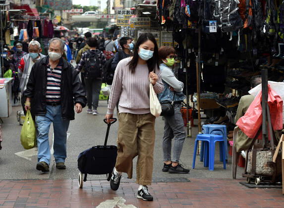 (210121) -- HONG KONG, Jan. 21, 2021 -- People wearing face masks walk on a street in Hong Kong, south China, Jan. 21, 2021. Hong Kong s Center for Health Protection (CHP) reported 70 additional confirmed cases of COVID-19 on Thursday, taking its total tally to 9,867. ) CHINA-HONG KONG-COVID-19-CASES (CN) LoxPingxFai