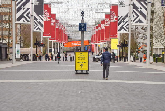 January 21, 2021, London, United Kingdom: A man walks past a sign for the NHS covid-19 Vaccine Centre in Wembley..Several mass vaccination sites have been opened around England, as the government rolls out its coronavirus vaccination program. London United Kingdom - ZUMAs197 20210121_zaa_s197_058 Copyright: xVukxValcicx