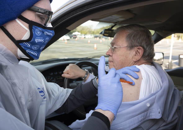 January 21, 2021, Round Rock, Texas, USA: South University nursing student ZACH BEYER administers the COVID-19 vaccine to BOB FARMER of Liberty Hill as central Texans line up at a drive-through clinic on January 21, 2021. Over 2,000 doses were given in people s arms on the previous day as Texas ramps up its vaccine response. Round Rock USA - ZUMAd150 20210121_znp_d150_013 Copyright: xBobxDaemmrichx