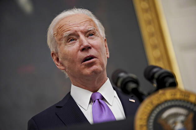 U.S. President Joe Biden holds a protective mask while speaking during an event on his administration s Covid-19 response in the State Dining Room of the White House in Washington, D.C., U.S., on Thursday, Jan. 21, 2021. Biden in his first full day in office plans to issue a sweeping set of executive orders to tackle the raging Covid-19 pandemic that will rapidly reverse or refashion many of his predecessor s most heavily criticized policies.  WAXP20210121104 AlxDrago