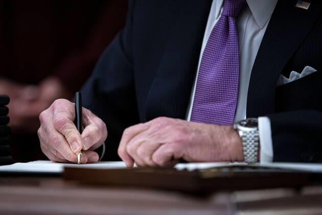 U.S. President Joe Biden signs an executive order after speaking during an event on his administration s Covid-19 response in the State Dining Roomof the White House in Washington, D.C., U.S., on Thursday, Jan. 21, 2021. Biden in his first full day in office plans to issue a sweeping set of executive orders to tackle the raging Covid-19 pandemic that will rapidly reverse or refashion many of his predecessor s most heavily criticized policies.  WAXP20210121122 AlxDrago