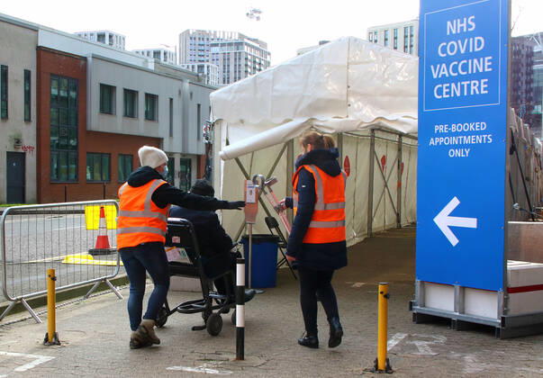 January 21, 2021, London, United Kingdom: A medical steward checks in people into the vaccination centre..A steady stream of elderly people with pre-booked appointments at the new Covid-19 Vaccination hub at the Olympic Office Centre, near London s Wembley Stadium. .It is one of 10 new large scale Vaccination centres opened this week, to join the seven already in use across the country. So far 4.9 million people across the UK have received the first dose of vaccine and the government aims for that number to rise to 15 million by 15 February. London United Kingdom - ZUMAs197 20210121_zaa_s197_156 Copyright: xKeithxMayhewx