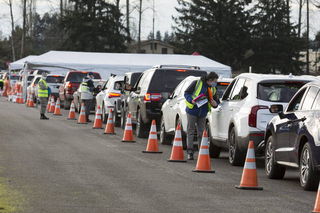 January 22, 2021, Monroe, Washington, USA: Workers screen patients as they arrive at a COVID-19 vaccination site at the Evergreen State Fairgrounds in Monroe, Washington on Friday, January 22, 2021. The site reopened today after closing on Thursday due to a shortage of vaccine stock. This week, Washington State moved to Phase 1B tier 1 making vaccines available to anyone 65 and older and all peopleÃ‚ 50 and older who also live in a multigenerational household. Monroe USA - ZUMAg235 20210122_zap_g235_003 Copyright: xPaulxChristianxGordonx