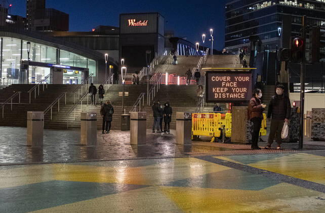 January 23, 2021, London, United Kingdom: People are seen by the COVID sign read â€oeCover your face. Keep your distance†in Stratford, the London Borough of Newham, England, UK on January 23, 2021. Some of England s Covid hotspots are still in London Hounslow, Ealing, Brent, Barking and Dagenham and Newham are the boroughs which fall in the country s top 10 for worst case rates. London United Kingdom - ZUMAj323 20210123_zip_j323_014 Copyright: xMayxJamesx