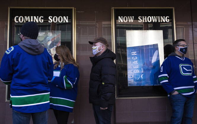 January 23, 2021, Vancouver, BC, Canada: Canucks fans line up outside the Rio Theatre in Vancouver, Saturday, Jan. 23, 2021. The independent movie theatre, which has been closed due to provincial public health restrictions, is now open as a sports bar. Vancouver Canada  - ZUMAc35_ 20210123_zaf_c35_056 Copyright: xMarissaxTielx