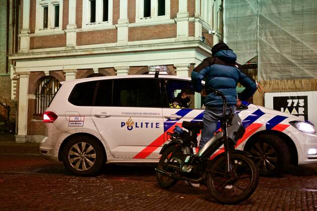 (210124) -- THE HAGUE, Jan. 24, 2021 -- A police officer checks a passer-by in Haarlem, the Netherlands, Jan. 23, 2021. A curfew to curb the spread of COVID-19 came into force in the Netherlands between 9 pm on Saturday and 4:30 am on Sunday and is scheduled to remain in force every night until Feb. 9. In addition, the Netherlands will suspend all flights from Great Britain, South Africa and South American countries as of Saturday. (Photo by Xinhua) NETHERLANDS-HAARLEM-COVID-19-CURFEW SylviaxLederer 
