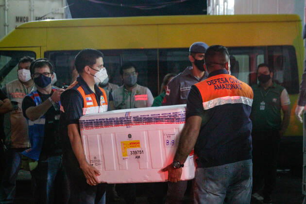 MANAUS, AM - 24.01.2021: CHEGADA DAS VACINAS ASTRAZENECA EM MANAUS - Arrival of the 132,500 doses of the AstraZeneca Oxford vaccine, this Saturday night (23), in Manaus (AM), at Eduardo Gomes International Airport. The boxes with the vaccines were taken to the headquarters of the Health Surveillance Foundation (FVS-AM). In the photo, soldiers of the PM help to unload the boxes with vaccines at the headquarters of FVS-AM. x2023656x  SandroxPereira