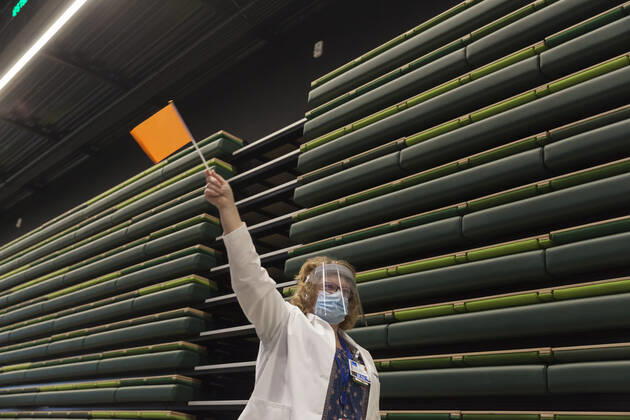 January 24, 2021, Seattle, Washington, U.S: SHARON WATTS, a nurse manager with with Virginia Mason, waves a flag to notify the next patient at a pop up COVID-19 vaccine clinic at the Amazon Headquarters in Seattle on Sunday, January 24, 2021. Amazon partnered with Virginia Mason Franciscan Health to vaccinate 2,000 Washingtonians who currently qualify to be vaccinated under the stateÃ¢â‚¬â ¢s COVID-19 Vaccine Phases guidelines. Seattle U.S. - ZUMAg235 20210124_zap_g235_004 Copyright: xPaulxChristianxGordonx