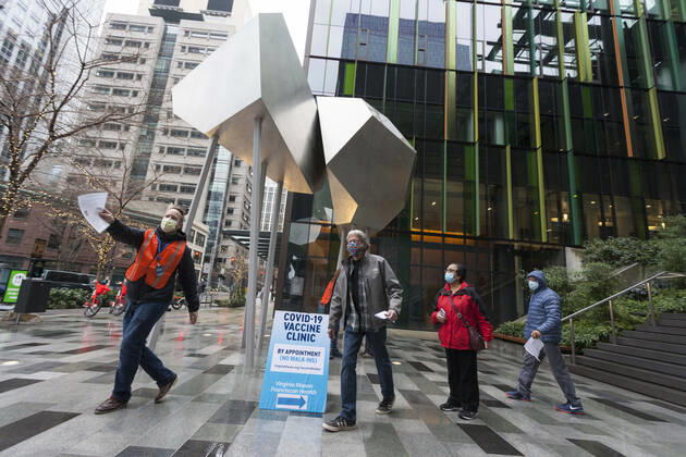 January 24, 2021, Seattle, Washington, U.S: Workers guide patients to the end of the line as they arrive at a pop up COVID-19 vaccine clinic at the Amazon Headquarters in Seattle on Sunday, January 24, 2021. Amazon partnered with Virginia Mason Franciscan Health to vaccinate 2,000 Washingtonians who currently qualify to be vaccinated under the stateÃ¢â‚¬â ¢s COVID-19 Vaccine Phases guidelines. Seattle U.S. - ZUMAg235 20210124_zap_g235_002 Copyright: xPaulxChristianxGordonx