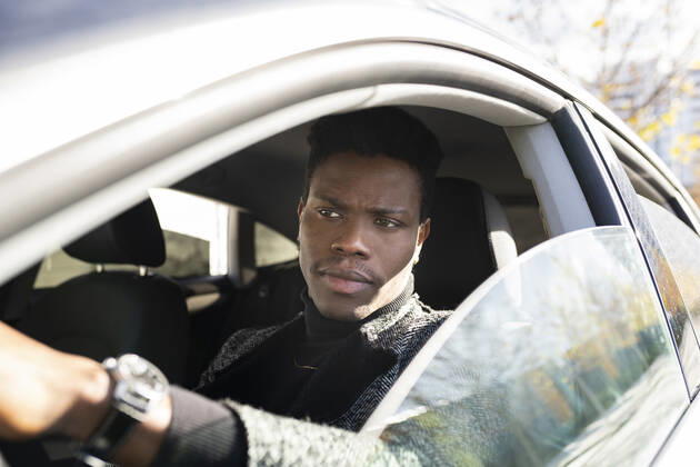 Young man driving car model released Symbolfoto JCCMF00790