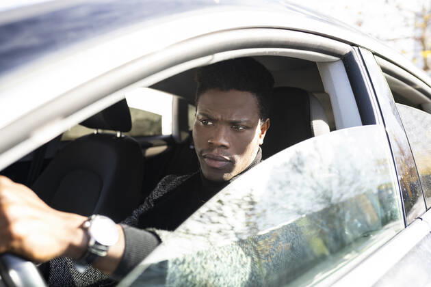Young man driving car model released Symbolfoto JCCMF00791