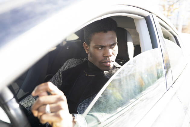 Young man driving car model released Symbolfoto JCCMF00794