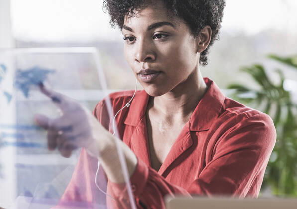 Woman pointing at transparent display at home model released Symbolfoto property released UUF22466