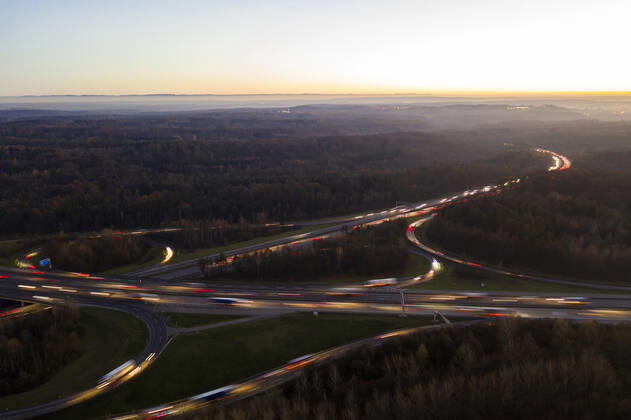 Germany, Baden-Wurttemberg, Stuttgart, Aerial view of vehicle light trails on Bundesautobahn 8 at sunset WDF06441