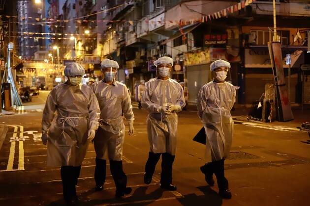 January 25, 2021, Hong Kong, CHINA: Government staffs dressed in full protective gear walk through Temple Street in the early morning. Hong Kong Government have lifted partial lockdown in the designated zone after imposing 48 hours of restriction on local citizens.Jan-25,2021Hong Kong.ZUMA Hong Kong CHINA - ZUMAl137 20210125_zap_l137_010 Copyright: xLiauxChung-renx