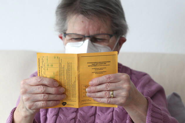 Winden Themenbild - Coronavirus, Coronapandemie - Patientin einer Risikogruppe mit internationale Impfbescheinigung, Prophylaxebescheinigung, Impfpass, Impfbuch Themenbild - Coronavirus, Coronapandemie - Patientin einer Risikogruppe mit internationale Impfbescheinigung, Prophylaxebescheinigung, Impfpass, Impfbuch Coronavirus, Coronapandemie - Impfpass, Impfbuch, Impfbescheinigung, Impfdokument, internationale Impfbescheinigung, Prophylaxebescheinigung. Eine ältere Person, Rentnerin, einer Risikogruppe, mit 80 Jahren, sitzt in ihrem Wohnzimmer auf der Couch, Sofa und hält ihren gelben Impfpass für die bevorstehende Corona Schutzimpfung in der Hand, in den älteren, runzligen Fingern ihrer Händen. Model release Vertrag liegt vor. Model Copyright: xFleigx xEibner-Pressefotox EP_dfg