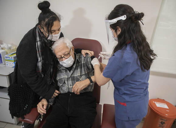 (210127) -- ISTANBUL, Jan. 27, 2021 -- A man receives a dose of COVID-19 vaccine in Istanbul, Turkey, Jan. 27, 2021. A state hospital in Turkey s largest city Istanbul Wednesday was filled with senior citizens who came to be vaccinated against COVID-19 as part of the ongoing mass inoculation program in the country. TO GO WITH Feature: Turkish seniors hope pandemic to end with COVID-19 vaccines (Photo by Xinhua) TURKEY-ISTANBUL-VACCINATION OsmanxOrsal 