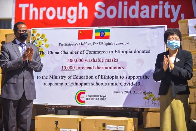 (210127) -- ADDIS ABABA, Jan. 27, 2021 -- Liu Yu (R), minister counselor for Economic and Commercial Affairs of the Chinese Embassy to Ethiopia, and Getahun Mekuria, Ethiopia Minister of Education, attend a donation ceremony in Addis Ababa, Ethiopia on Jan. 26, 2021. The China Chamber of Commerce in Ethiopia (CCCE) on Tuesday donated 500,000 washable masks and 10,000 thermometers to the Ethiopia Ministry of Education (MoE). ) ETHIOPIA-CHINA-DONATION CEREMONY-MEDICAL SUPPLIES MichaelxTewelde