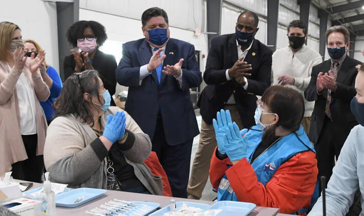 January 27, 2021, Grayslake, Illinois, USA: 600 doses of the Moderna and Pfizer vaccines against COVID-19 were expected to be administered to people in Phase 1a at the Lake County Fairgrounds and Event Center in Grayslake, Illinois Wednesday January 27, 2021. Some people were getting their first vaccine dose, others their second. Officials hope to boost up to 1,000 doses per session next week. ILLINOIS GOV. J.B. PRITZKER (blue suit, blue mask, blue tie) leads applause for workers as he tours the site and announced that governors have been told to expect increased shipments of vaccines to their states, beginning next week. Grayslake USA - ZUMAh154 20210127_znp_h154_033 Copyright: xMarkxHertzbergx