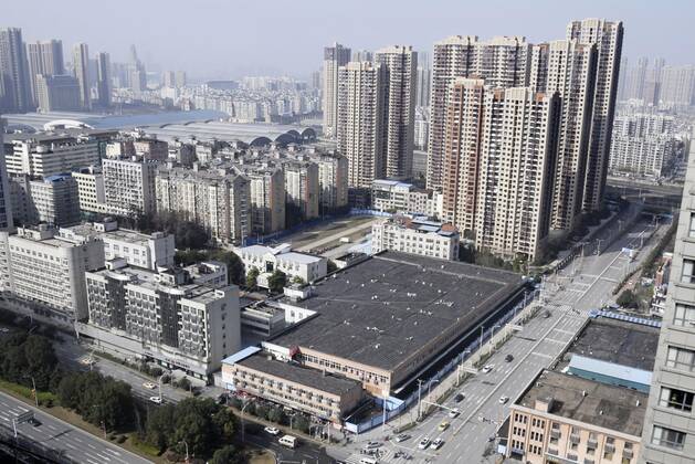 WHO probe into coronavirus origins in Wuhan Photo taken Jan. 28, 2021, shows a building (C) that houses the Huanan seafood wholesale market in Wuhan, China. Experts from the World Health Organization started a full-fledged investigation the same day in the city, where the novel coronavirus was first detected in late 2019. 