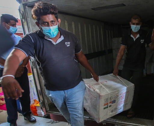 January 28, 2021, Colombo, Sri Lanka: Sri Lankan health services workers unload a consignment of Oxford-AstraZeneca vaccine donated by Indian government at a Central Vaccine Store in Colombo, Sri Lanka on January 28, 2021. Sri Lanka s president welcomed the first 500,000 doses of a COVID-19 vaccine from India, which has donated the shots to eight countries in the region. Colombo Sri Lanka - ZUMAd152 20210128_znp_d152_001 Copyright: xPradeepxDambaragex