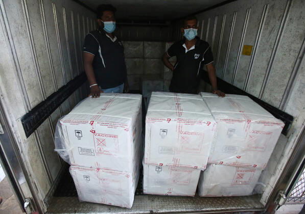 January 28, 2021, Colombo, Sri Lanka: Sri Lankan health services workers stands in a truck next to a consignment of Oxford-AstraZeneca vaccine donated by Indian government at a Central Vaccine Store in Colombo, Sri Lanka on January 28, 2021. Sri Lanka s president welcomed the first 500,000 doses of a COVID-19 vaccine from India, which has donated the shots to eight countries in the region. Colombo Sri Lanka - ZUMAd152 20210128_znp_d152_002 Copyright: xPradeepxDambaragex