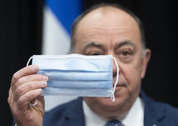 January 28, 2021, Quebec, PQ, Canada: Quebec Health Minister Christian Dube holds a procedural mask, one of the many they ordered from a Quebec company, during a news conference on the COVID-19 pandemic, Thursday, January 28, 2021 at the legislature in Quebec City. Quebec Canada  - ZUMAc35_ 20210128_zaf_c35_033 Copyright: xJacquesxBoissinotx