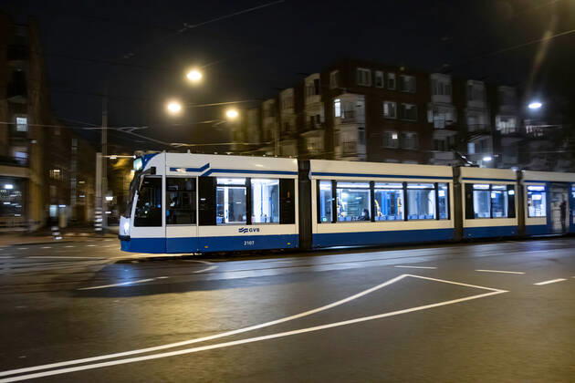 January 28, 2021, Amsterdam, Netherlands: A tram seen on an empty street in Amsterdam, with just a passenger inside, wearing a face mask during curfew hours..Police were deployed on the streets of Amsterdam for the night-time curfew that is applied from 21:00 local time until 04:30. The new Covid-19 mutation helps the infection number rise. The Dutch police is checking citizens for proper documents, permit from employers in order to be out after the curfew time. Most of the roads are empty after 21:00, deserted while public transportation vehicles are empty. The Netherlands faced some violent protests the previous days against the strict lockdown measures. Amsterdam Netherlands - ZUMAs197 20210128_zaa_s197_213 Copyright: xNikxOikox